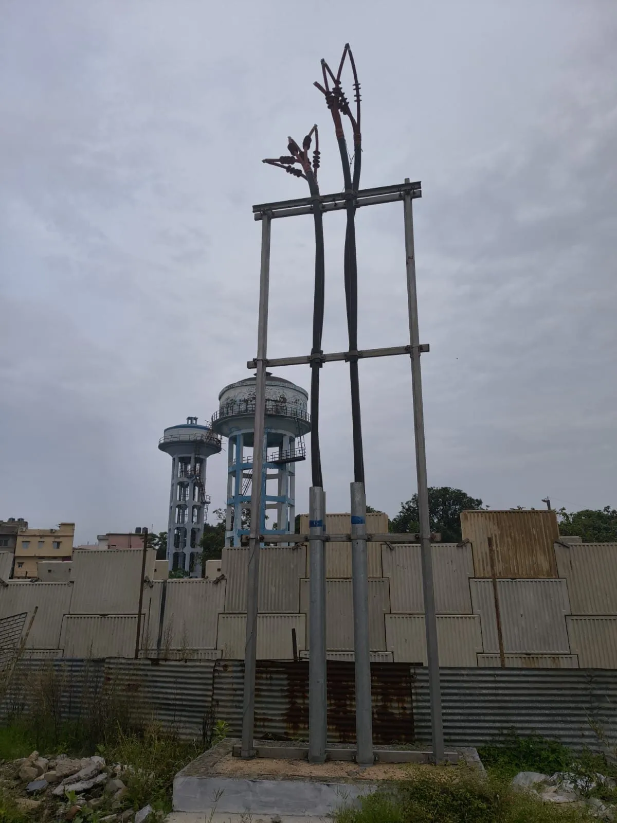 Overhead conductors terminated onto a steel gantry through strain insulators