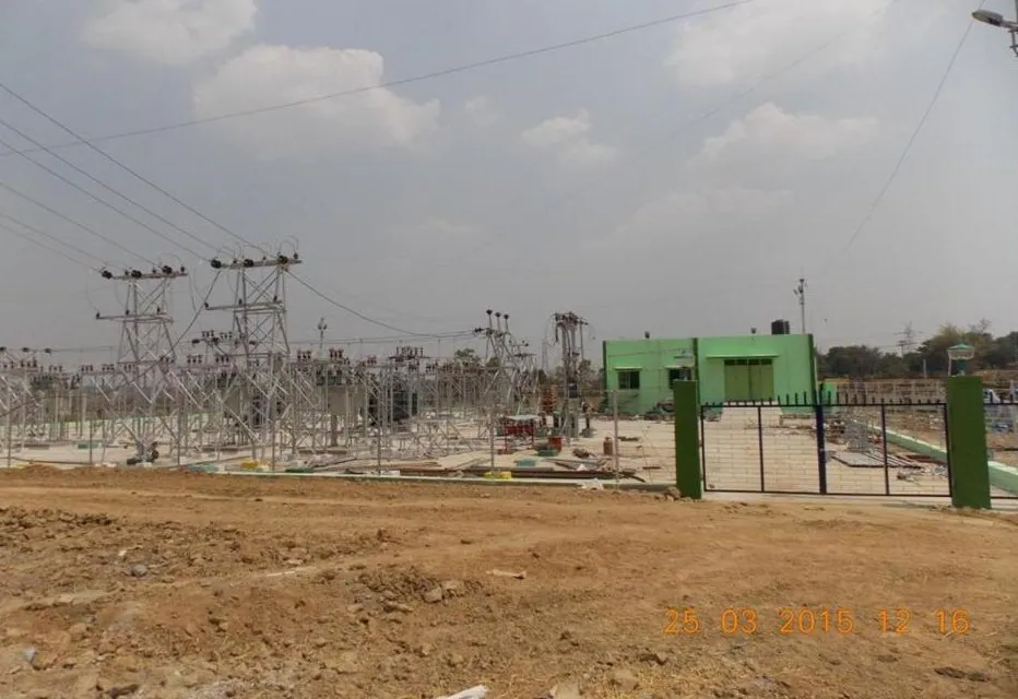 Switchyard under construction with structures erected and the control building behind