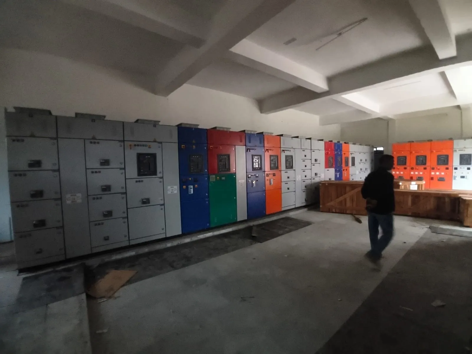 Long panel room with switchgear cubicles being installed down both walls