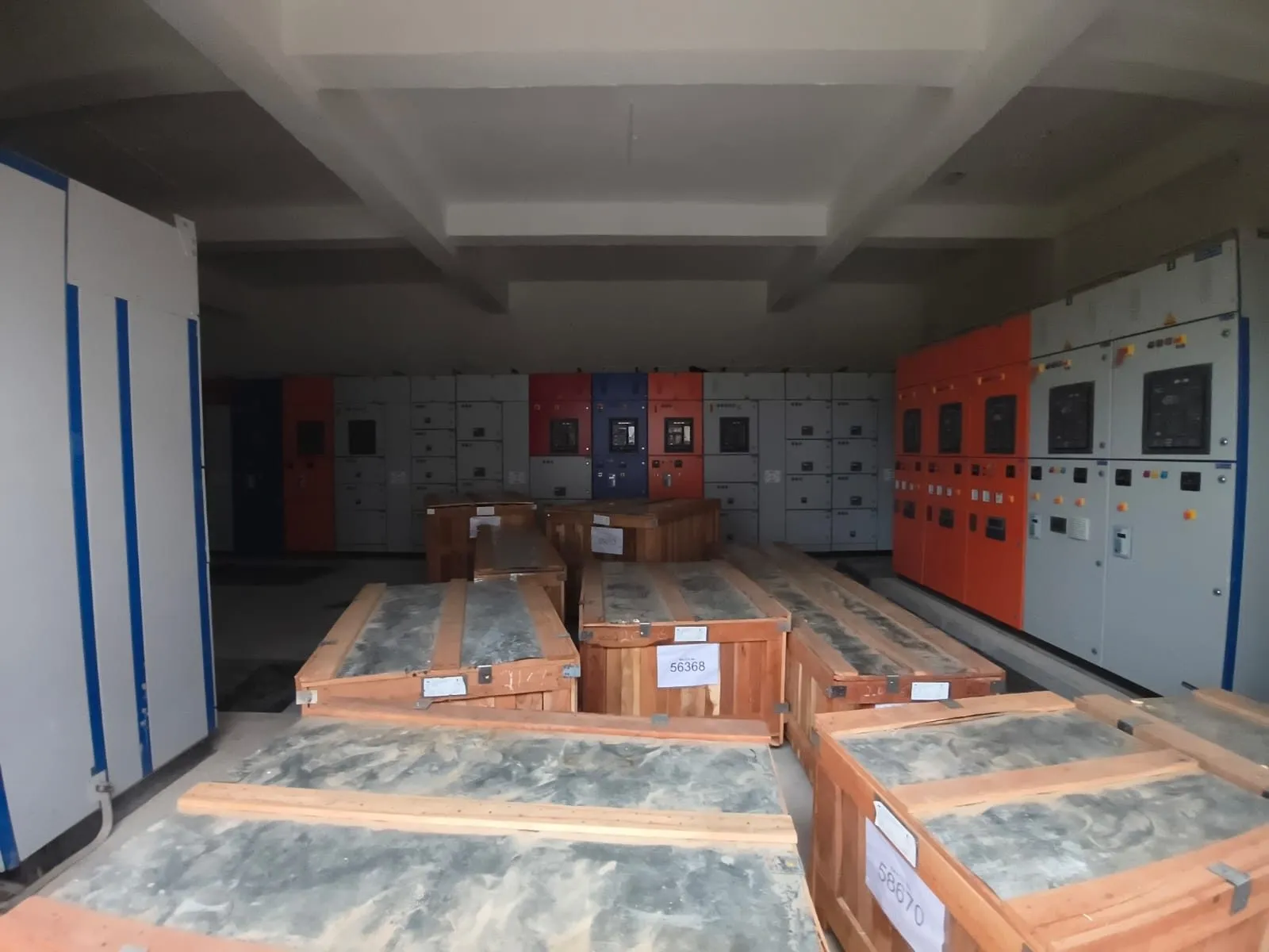 Switchgear panels still in timber crates standing in a finished panel room